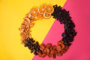 Dried fruit circle frame on bright background photo