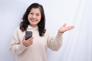 Portrait of senior Asian woman on white background photo