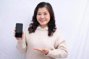 Portrait of senior Asian woman on white background photo