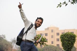 Portrait of he nice-looking attractive lovely lovable pretty cheerful Boy dancing having fun isolated over collage campus photo