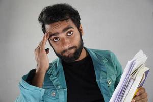 Having paper and books not intrested in stuy with white background photo