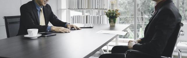 Businessman in formal suite interviewing candidate at office photo