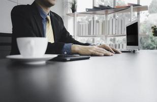 Businessman in formal suite sitting working in office photo