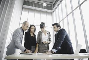 Group of businesspeople working meeting together in modern office photo