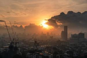 Sunrise over Bangkok city with crowded building in downtown photo