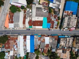 Old village and row house with zinc roof in the suburb and traffic on the road photo