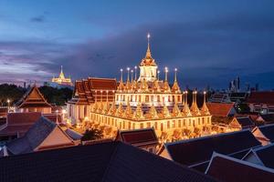 Golden metal castle illuminated, Wat Ratchanatdaram Woravihara, Loha Prasat temple in the morning at Bangkok photo