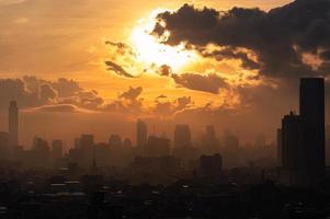 Sunrise over Bangkok city with high buildings in downtown photo