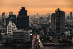 Cityscape of building with car traffic on the bridge in the monring at business district photo