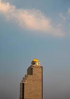 Retro golden dome high-rise condominium with many balcony layer and sunset sky in downtown