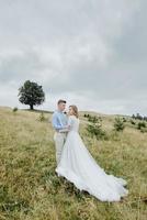 Photoshoot of the bride and groom in the mountains. Boho style wedding photo. photo