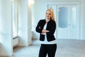 Happy business woman looking confident with modern building as b photo