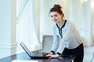 Happy Young Beautiful Woman Using Laptop, Indoors photo