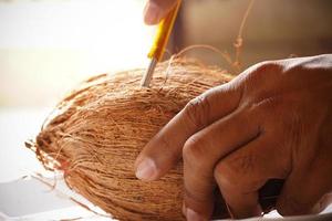 man peeling coconut from hand image indoor shoot photo