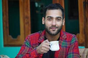 Young man with teacup at morning images photo