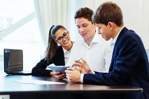 Group of students studying using a laptop photo