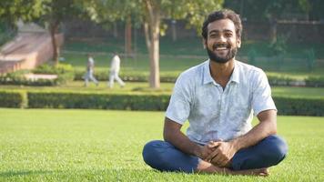 man smiling after meditation in park photo