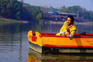 man enjoy with water sitting in the boat photo