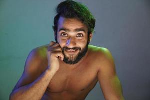 young man smiling face without cloths studio shot photo