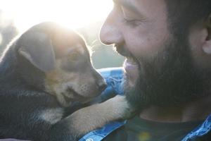 young boy with a cute puppy in park photo