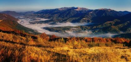 View of misty fog mountains in autumn, Carpathians, Ukraine. photo
