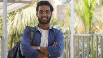 Man Standing and folding his hand smiling photo