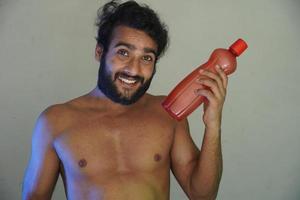 a healthy man with water bottle without cloths studio shot photo