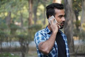 young man indian student talking on call portrait photo