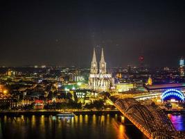 HDR Aerial night view of St Peter Cathedral and Hohenzollern Bri photo