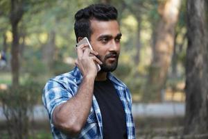 young man indian student talking on call portrait photo