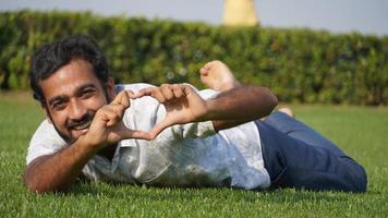 hombre en pasto y sonriendo foto