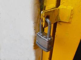 Locking a door with padlock photo