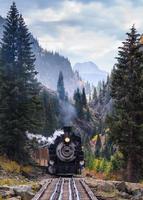 Vintage railroad steam engine in the Rocky Mountains. photo