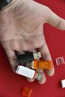 USB flash drive in the palm of your hand on a red background photo