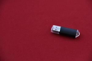 USB flash drive on a red background photo