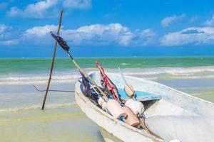 Beautiful Holbox island beach with fishing boat turquoise water Mexico. photo