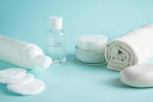 Cosmetic products and spa accessories on blue background. photo