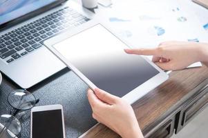 Business concept. Woman using tablet for project with digital device in office desk. Backlighting, sun glare effect, close up, side view, copy space photo