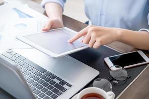 Business concept. Woman using tablet for project with digital device in office desk. Backlighting, sun glare effect, close up, side view, copy space photo