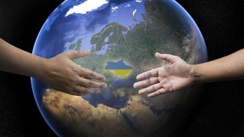 extending hand to unite russia and ukraine to make peace on the earth background.