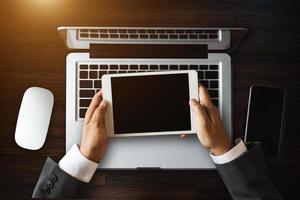 Top view business hand working with laptop computer, tablet and smart phone in office photo
