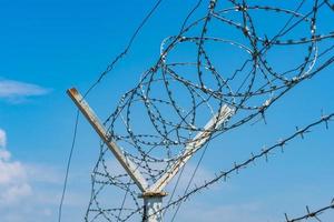 Barbed wire over the fence photo