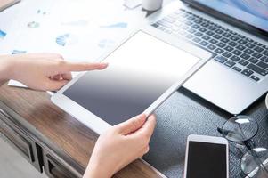 Business concept. Woman using tablet for project with digital device in office desk. Backlighting, sun glare effect, close up, side view, copy space photo
