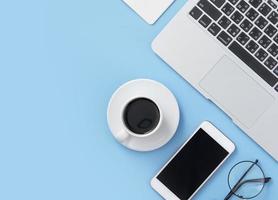 Freelancer blog writer woman drinking for relax on a clean light blue desk with coffee, work at home concept, copy space, flat lay, top view, mock up photo