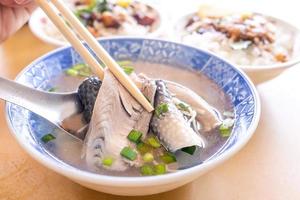 Milkfish skin soup, distinctive Taiwan delicacy food in Tainan. Famous meal set for lunch or breakfast with vegetable, top view, copy space, close up