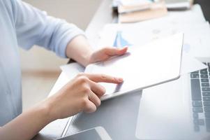 Business concept. Woman using tablet for project with digital device in office desk. Backlighting, sun glare effect, close up, side view, copy space photo
