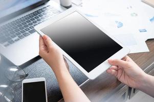 Business concept. Woman using tablet for project with digital device in office desk. Backlighting, sun glare effect, close up, side view, copy space photo