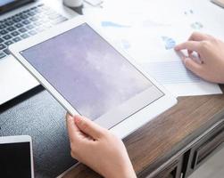 Business concept. Woman using tablet for project with digital device in office desk. Backlighting, sun glare effect, close up, side view, copy space photo