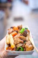 Pan-fried black pork meal in Korea traditional market, delicious korean food cuisine with carrot and shallot green onion, close up, copy space photo