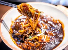 Jajangmyeon, jjajangmyeon, fried sauce noodle, delicious korean traditional noodles cuisine with korea black bean paste sauce, close up, copy space photo